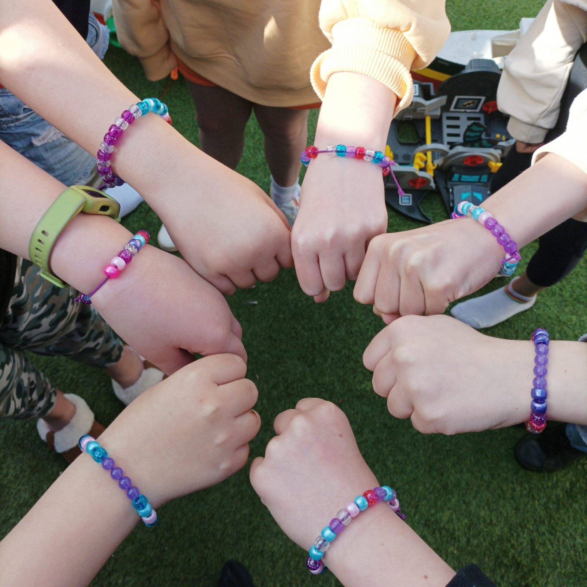children showing off their colour changing bracelets they just made