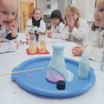 children watching an erupting potion at a Devon Science Party