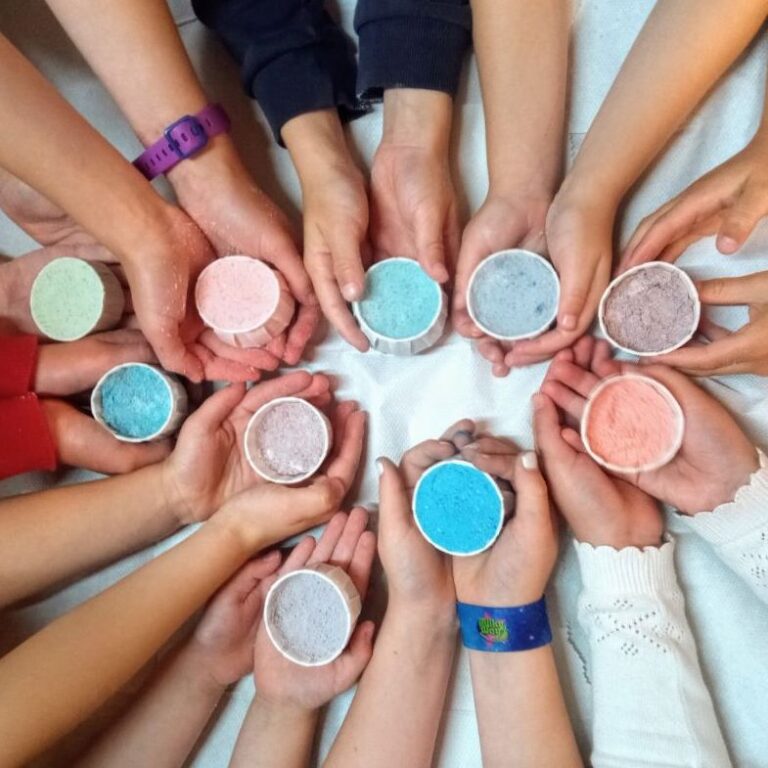 children holding out the bath bombs they have amde