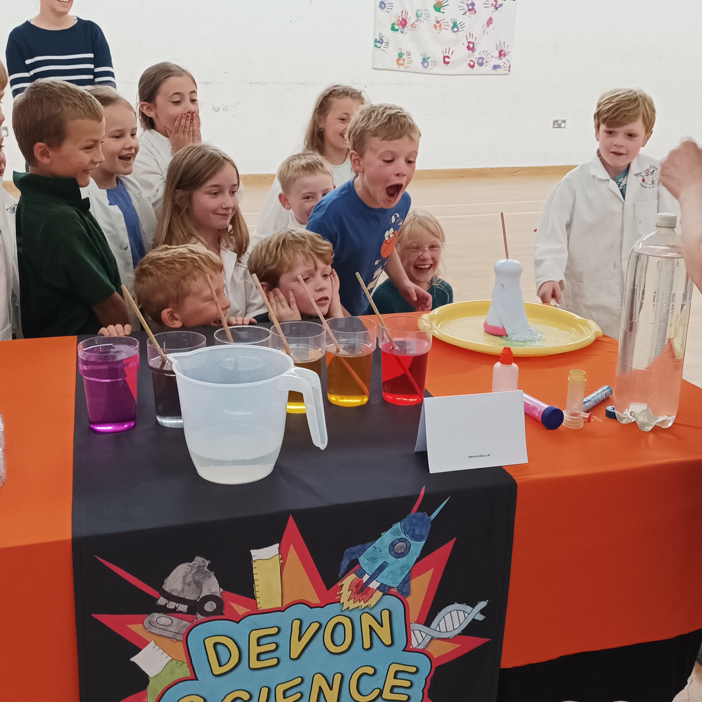 Children at a Devon Science Party watching excitedly at an erupting potion